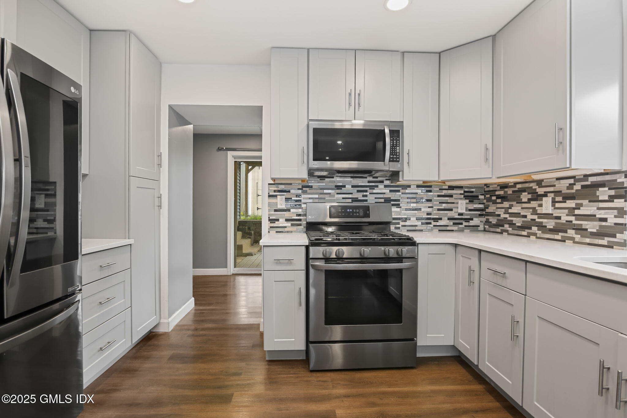 43 Cos Cob Avenue, Unit 1 Cos Cob, CT 06807 - Photo 4 of 10 a kitchen with stainless steel appliances a stove a microwave and a sink