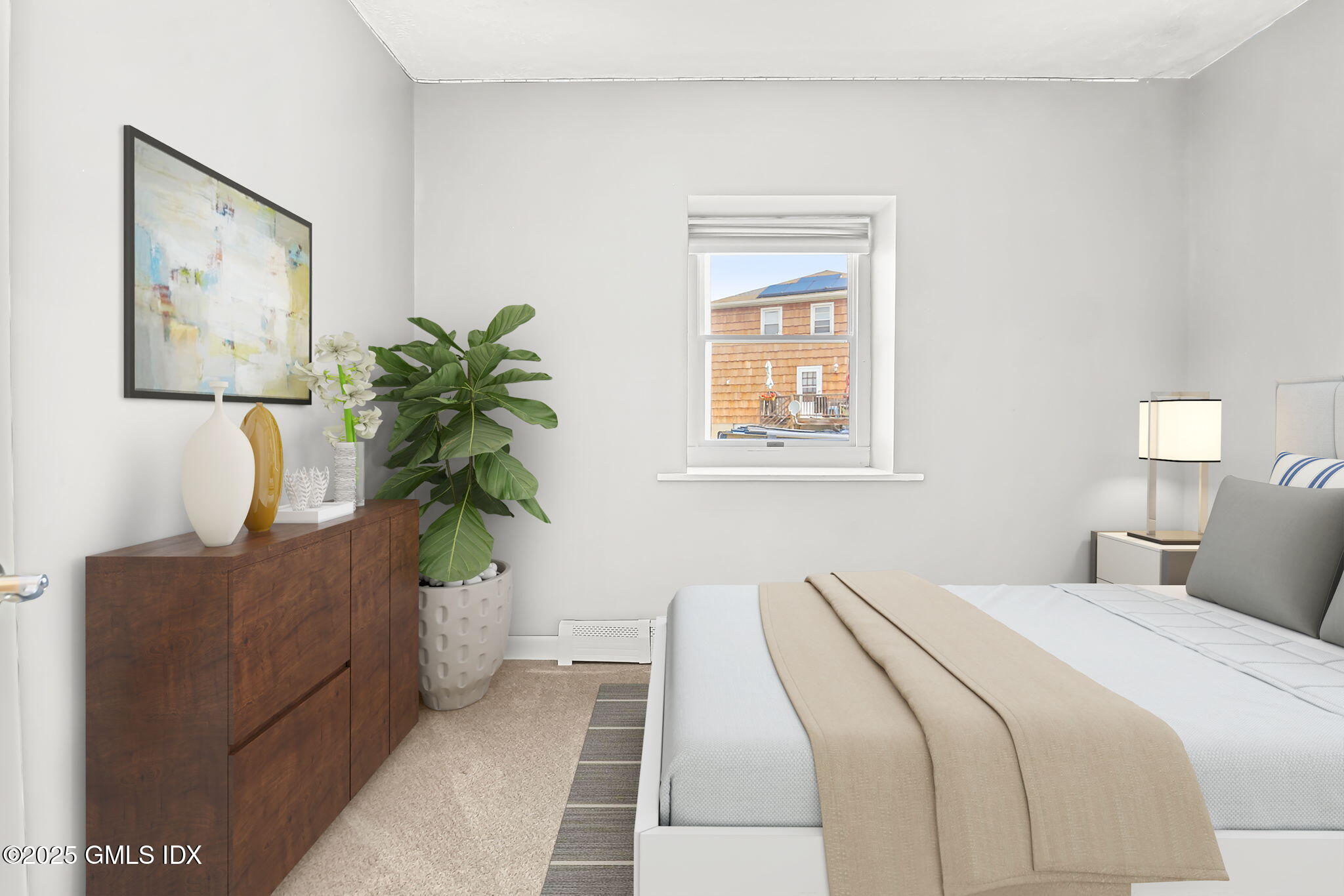 43 Cos Cob Avenue, Unit 1 Cos Cob, CT 06807 - Photo 9 of 10 a bedroom with a bed and a potted plant