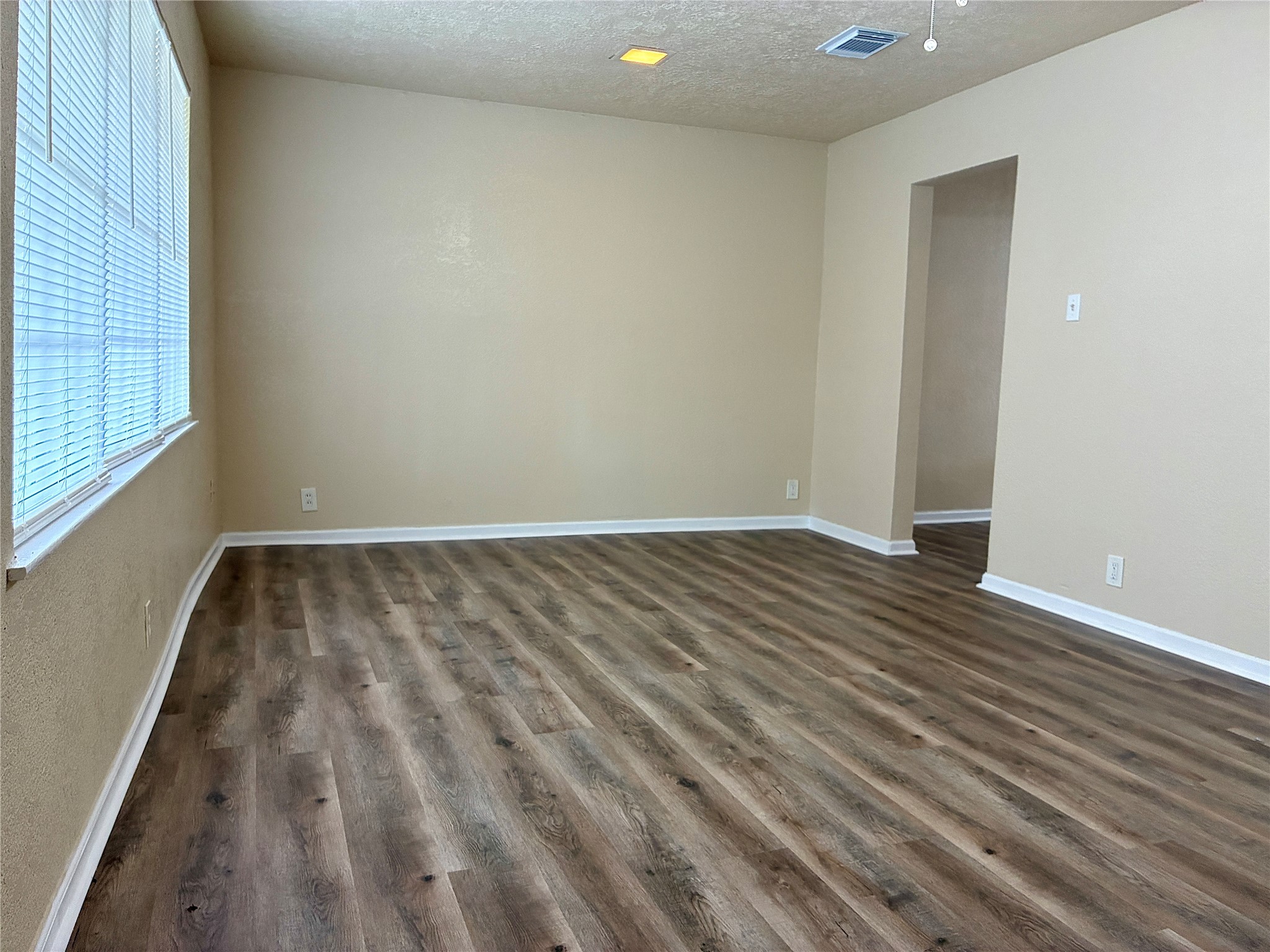 631 Roper Street Houston, TX 77034 - Photo 5 of 15 The living room features fresh paint, new vinyl plank flooring, and a new ceiling fan.