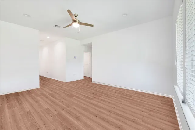 a view of an empty room and wooden floor
