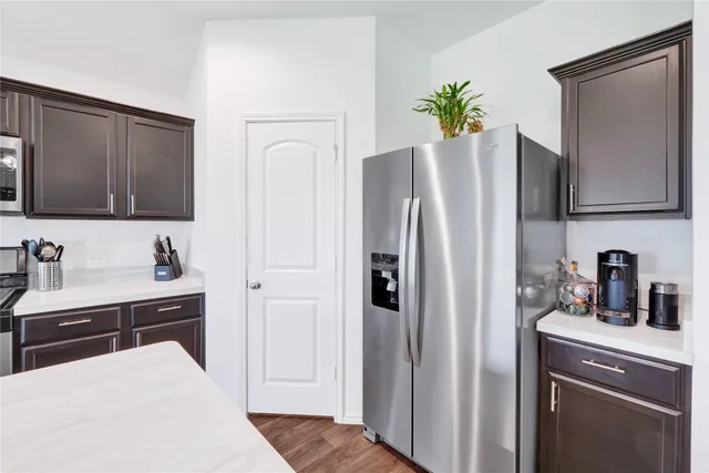 a kitchen with stainless steel appliances a refrigerator a sink a stove and cabinets