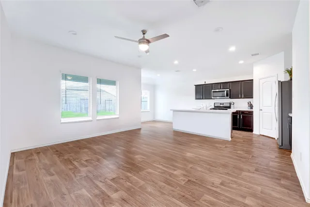 a view of kitchen with stove and cabinets