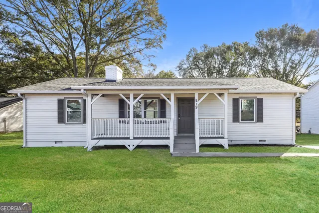 a front view of a house with a garden
