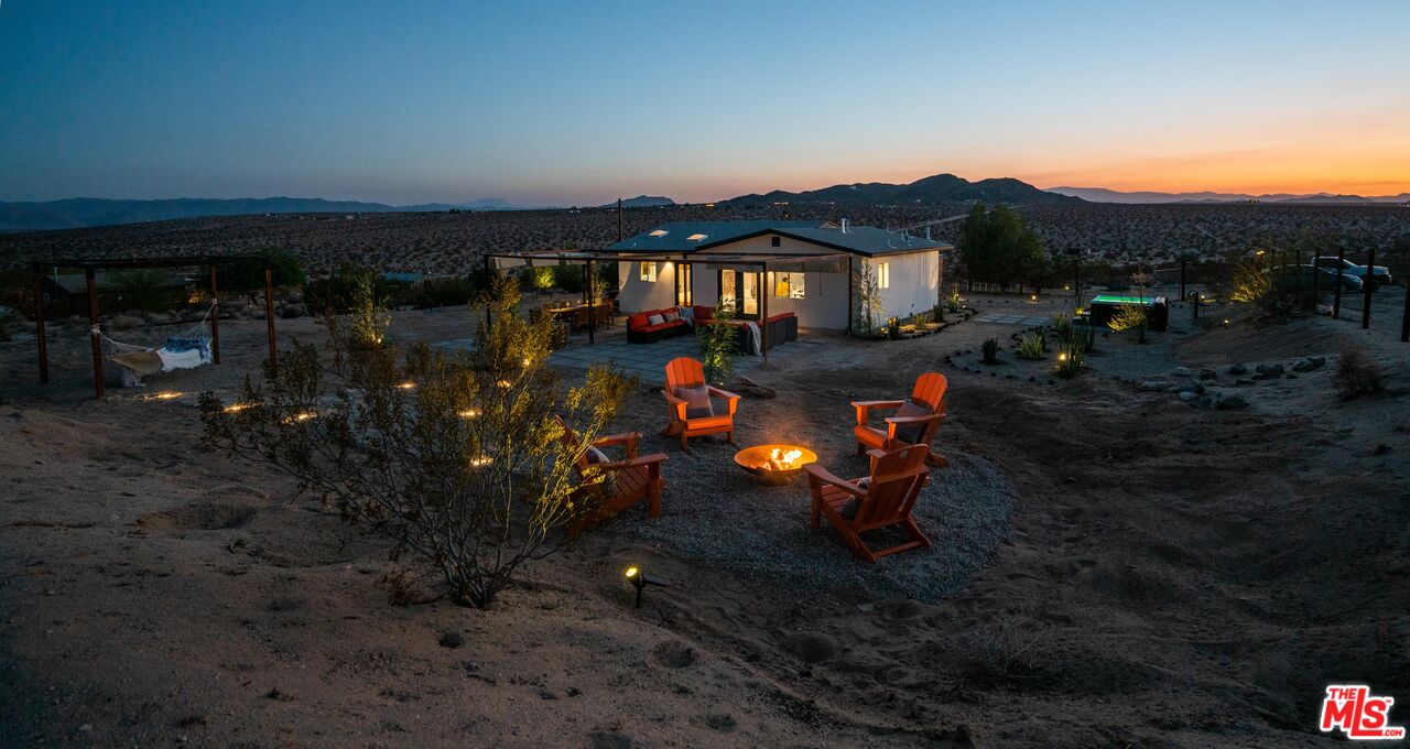 64428 Pole Line Road Joshua Tree, CA 92252 - Photo 3 of 54 a backyard of a house with table and chairs