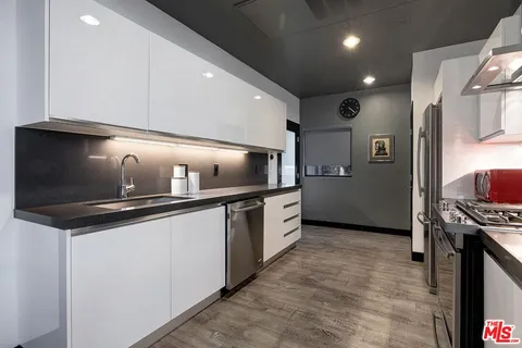 a kitchen with stainless steel appliances a sink and a stove