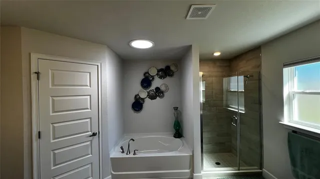 a bathroom with a bathtub and a shower