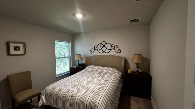 a bedroom with a bed and a chair