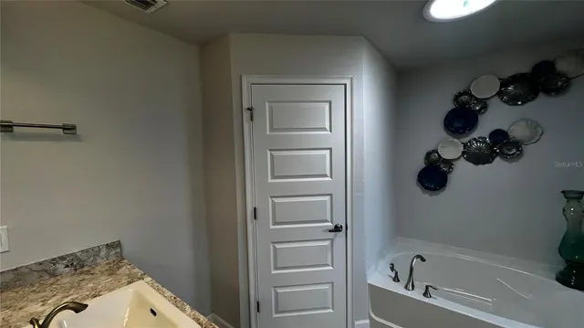 a bathroom with a bathtub and shower
