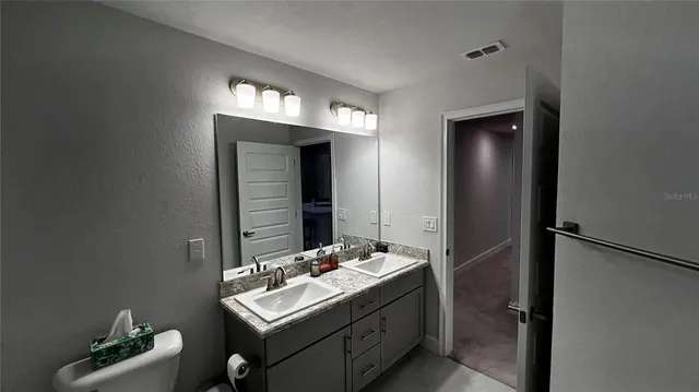 a bathroom with a sink and a mirror