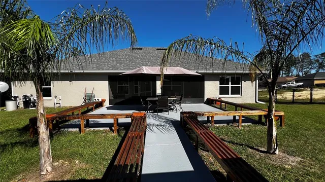 an outdoor view of house with swimming pool yard and outdoor seating