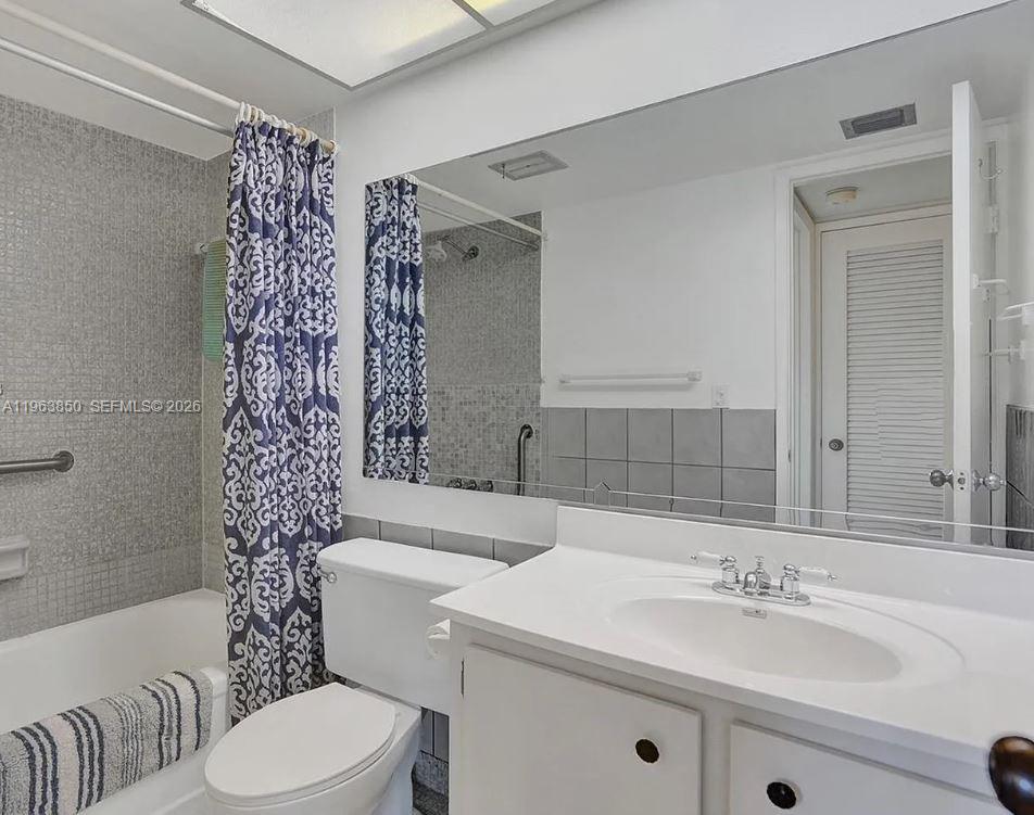 4047 Northwest 16th Street, Unit 403 Lauderhill, FL 33313 - Photo 11 of 22 a bathroom with a sink a toilet and shower