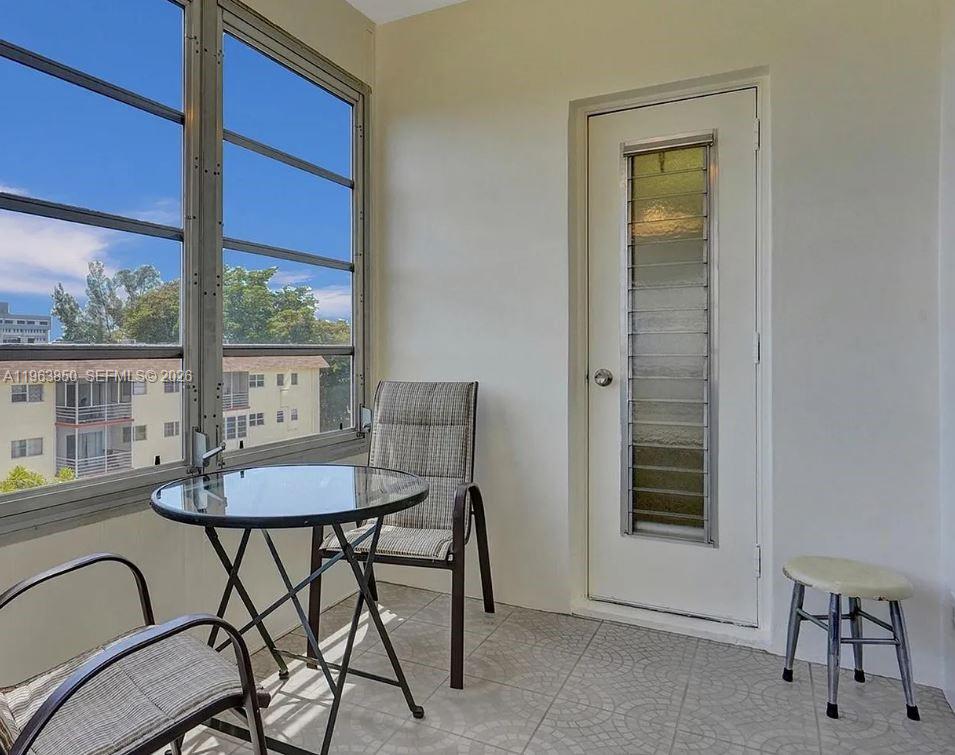 4047 Northwest 16th Street, Unit 403 Lauderhill, FL 33313 - Photo 16 of 22 a view of a dining room with furniture window and outside view