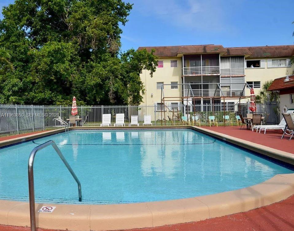 4047 Northwest 16th Street, Unit 403 Lauderhill, FL 33313 - Photo 17 of 22 a view of a swimming pool with a patio