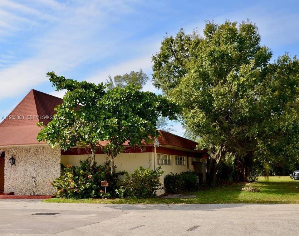 4047 Northwest 16th Street, Unit 403 Lauderhill, FL 33313 - Photo 21 of 22 front view of a house with a garden