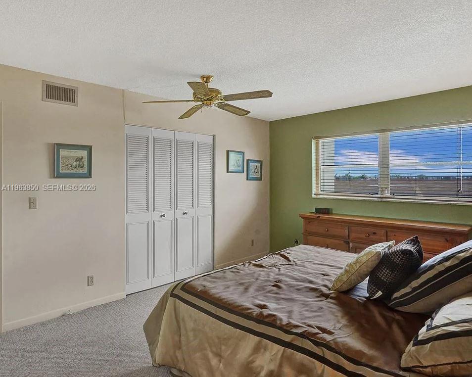 4047 Northwest 16th Street, Unit 403 Lauderhill, FL 33313 - Photo 5 of 22 a bedroom with a bed and ceiling fan