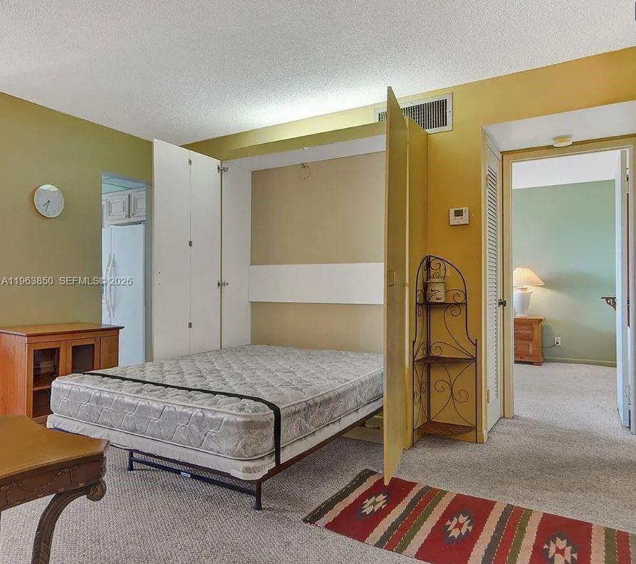 4047 Northwest 16th Street, Unit 403 Lauderhill, FL 33313 - Photo 7 of 22 a bedroom with a bed and a table