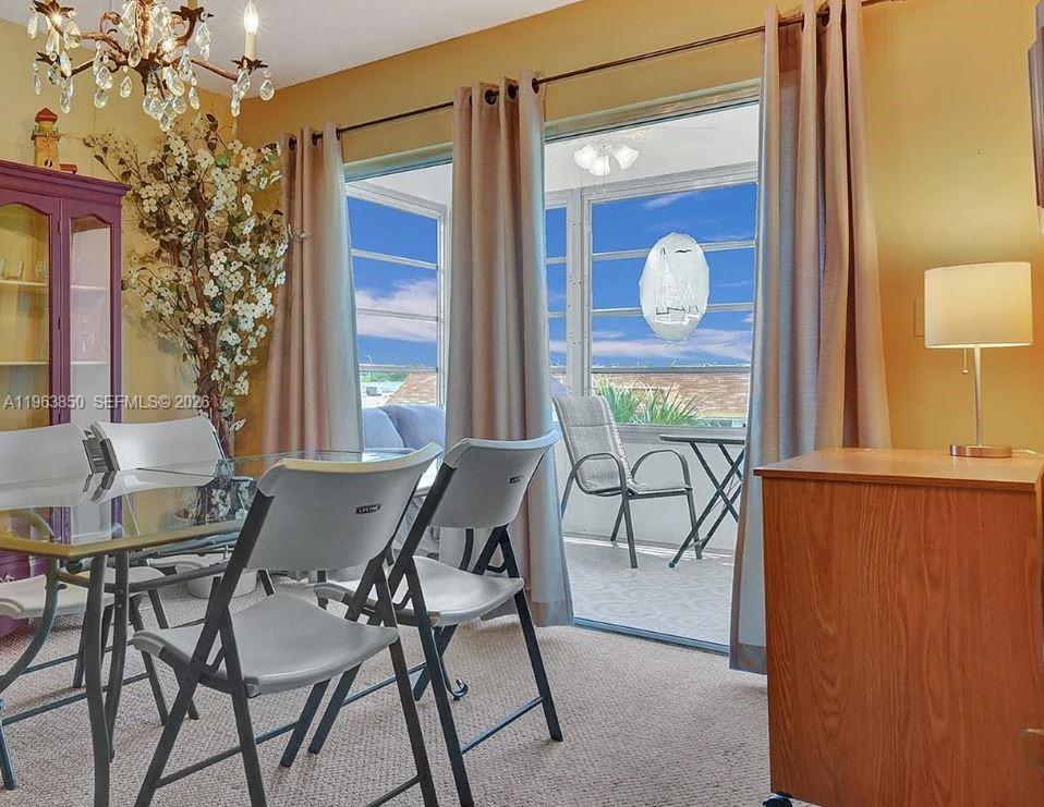 4047 Northwest 16th Street, Unit 403 Lauderhill, FL 33313 - Photo 8 of 22 a view of a dining room with furniture and window