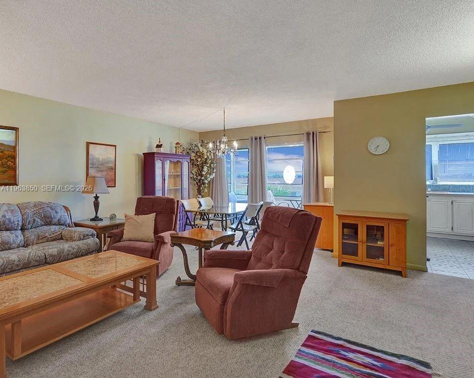 4047 Northwest 16th Street, Unit 403 Lauderhill, FL 33313 - Photo 9 of 22 a living room with furniture a flat screen tv and a fireplace