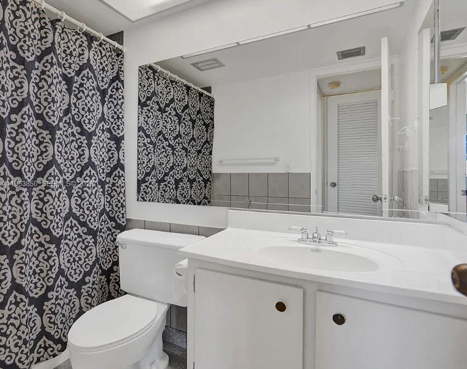 4047 Northwest 16th Street, Unit 403 Lauderhill, FL 33313 - Photo 10 of 22 a bathroom with a sink toilet and shower