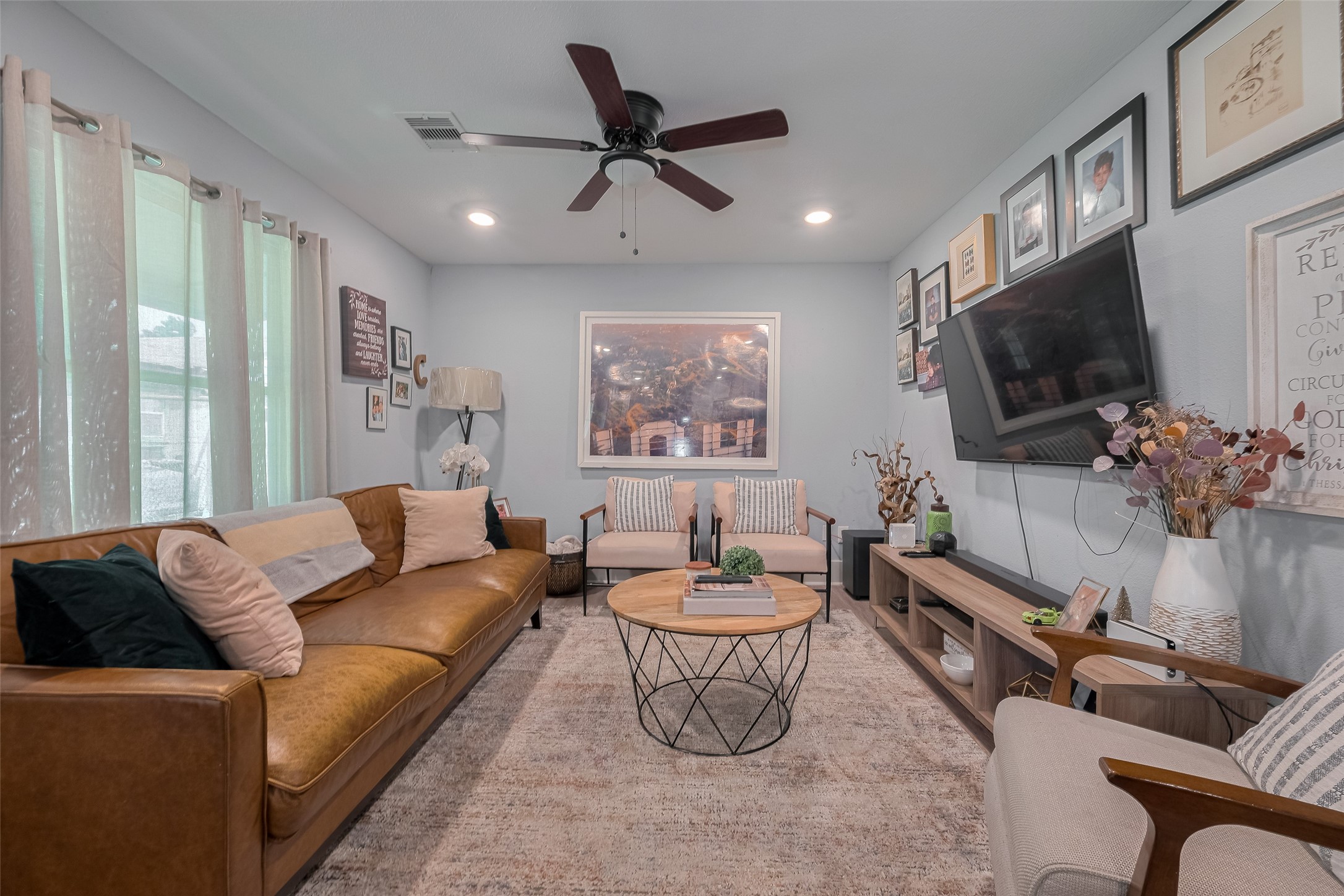a living room with furniture and a flat screen tv