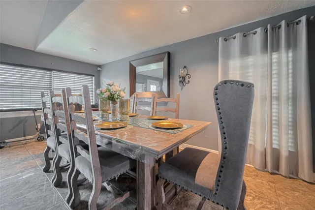 a view of a dining room with furniture and window