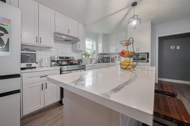 a kitchen with white cabinets and a sink