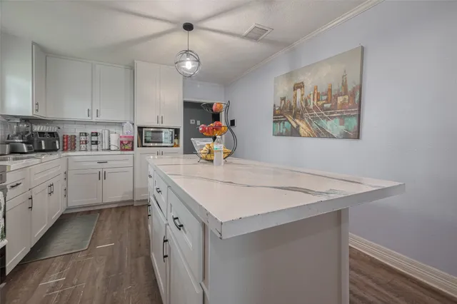 a kitchen that has a sink a stove and a refrigerator