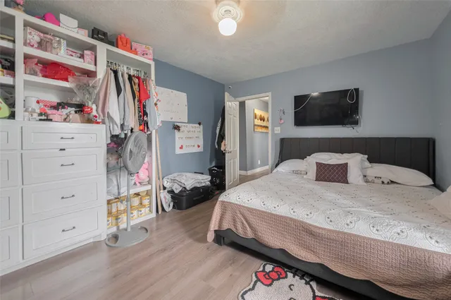 a bedroom with a bed and a flat screen tv