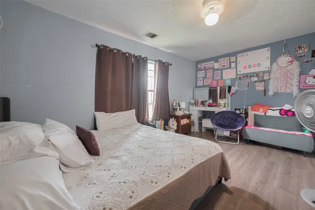 a bed room with a bed and a chair