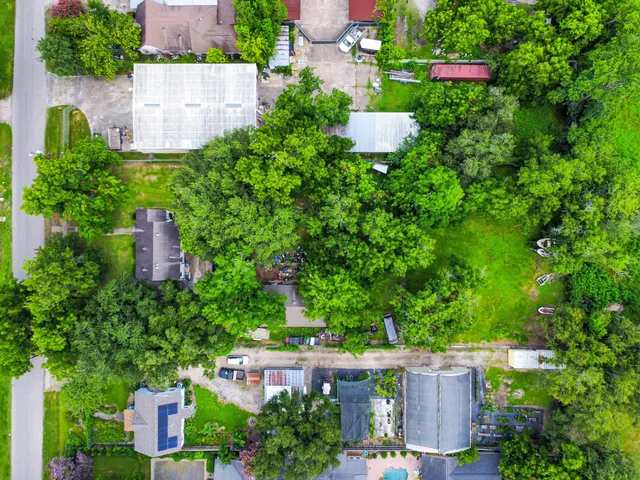 an aerial view of a house with a yard and plants