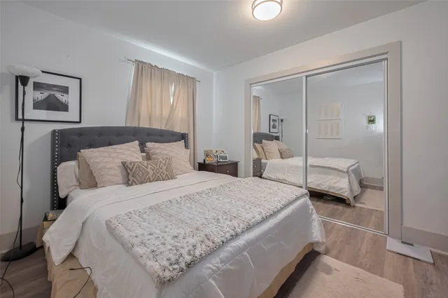 a bedroom with a bed and a large mirror