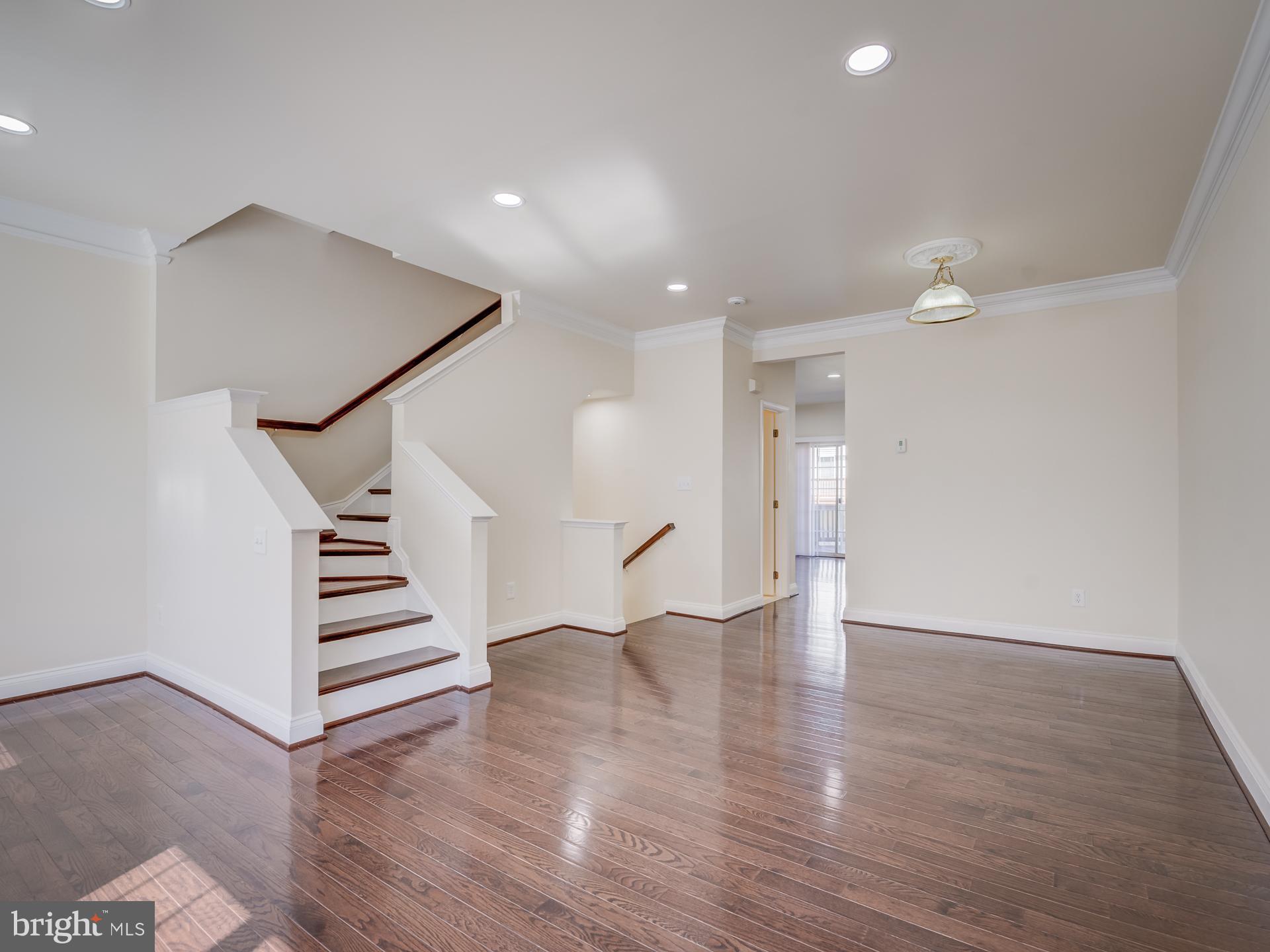 13510 Turquoise Lane Herndon, VA 20170 - Photo 11 of 54 a view of an empty room with wooden floor and stairs