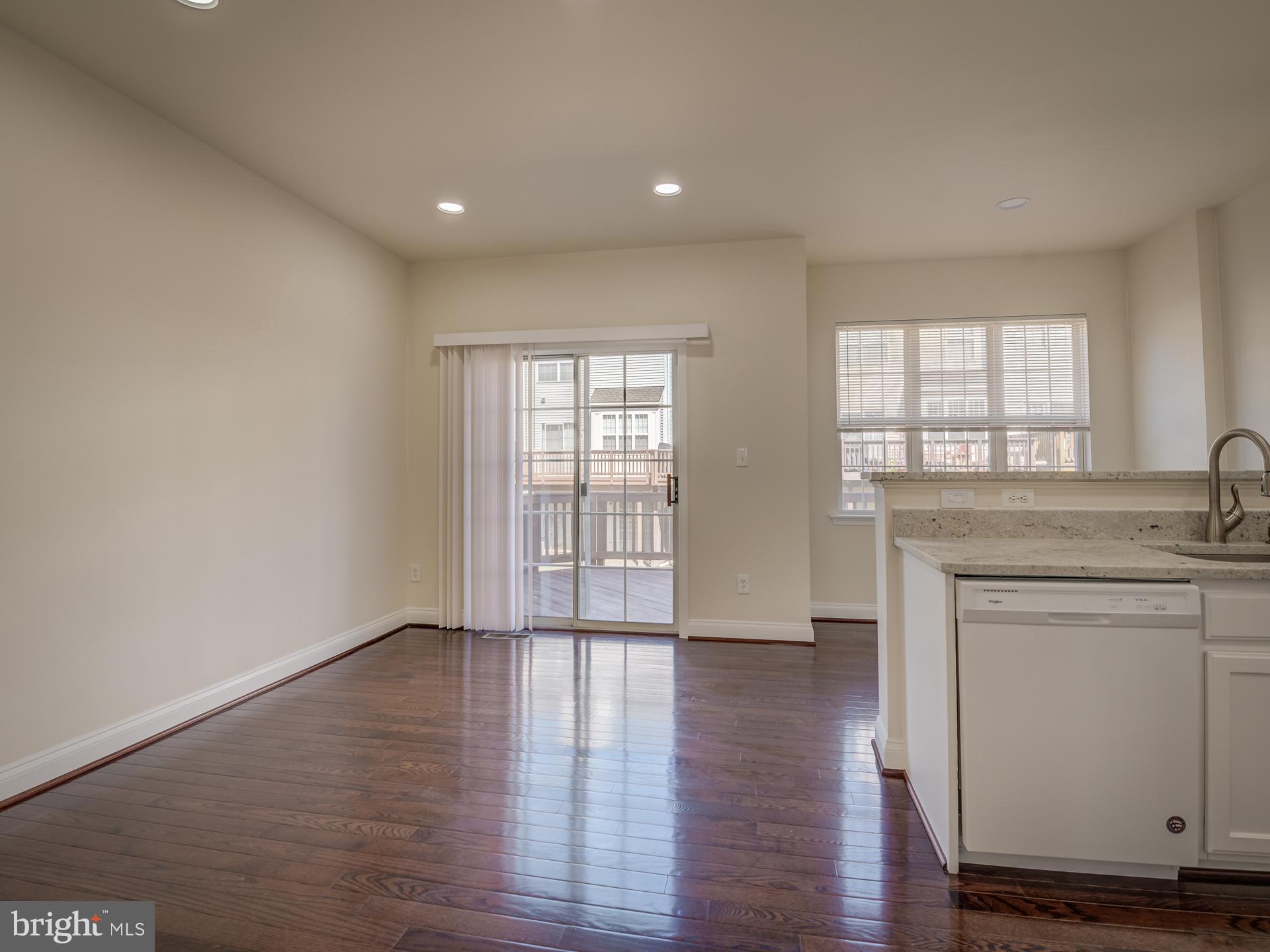 13510 Turquoise Lane Herndon, VA 20170 - Photo 14 of 54 a view of an empty room with a window and wooden floor