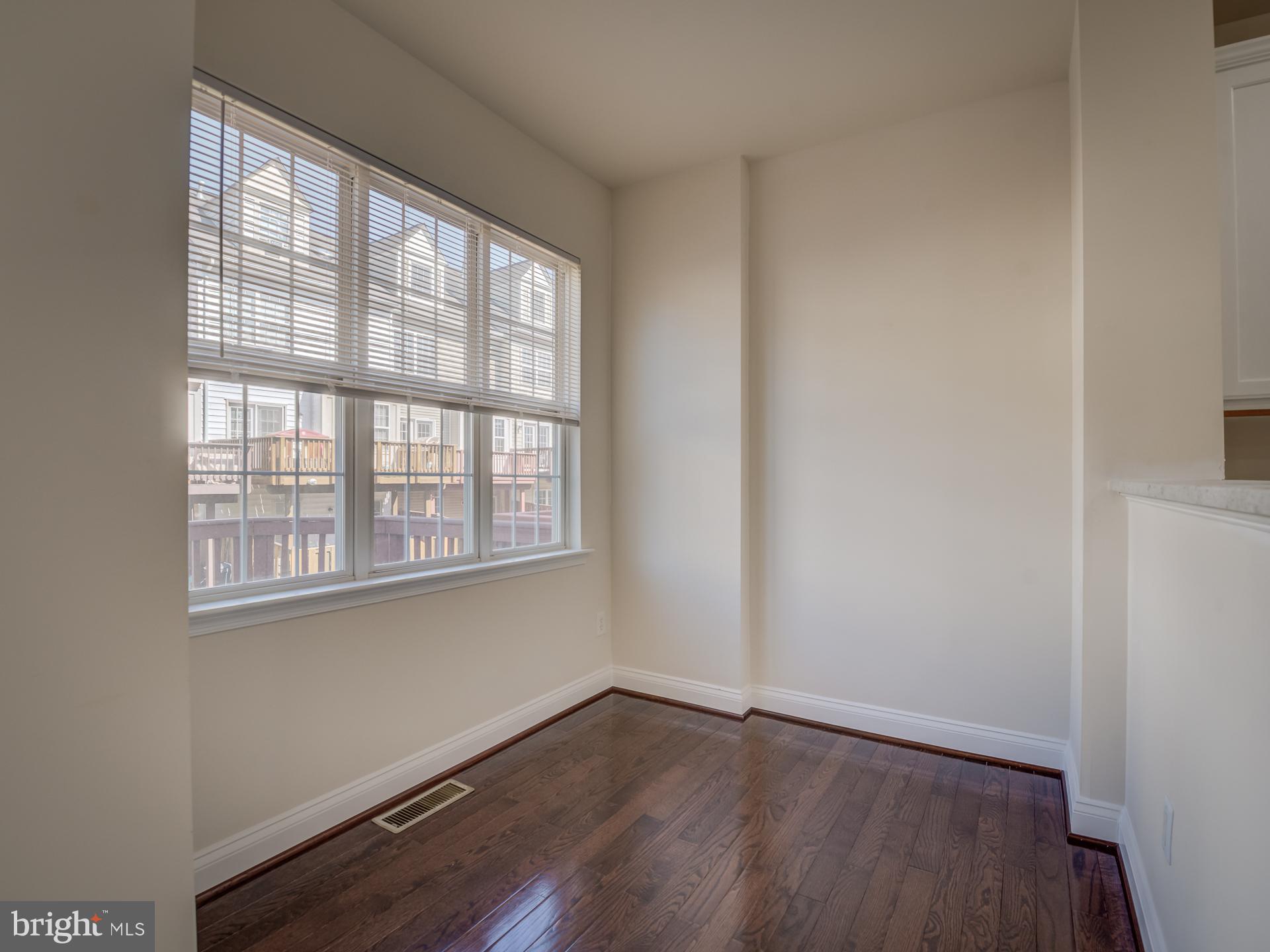 13510 Turquoise Lane Herndon, VA 20170 - Photo 17 of 54 an empty room with wooden floor and windows
