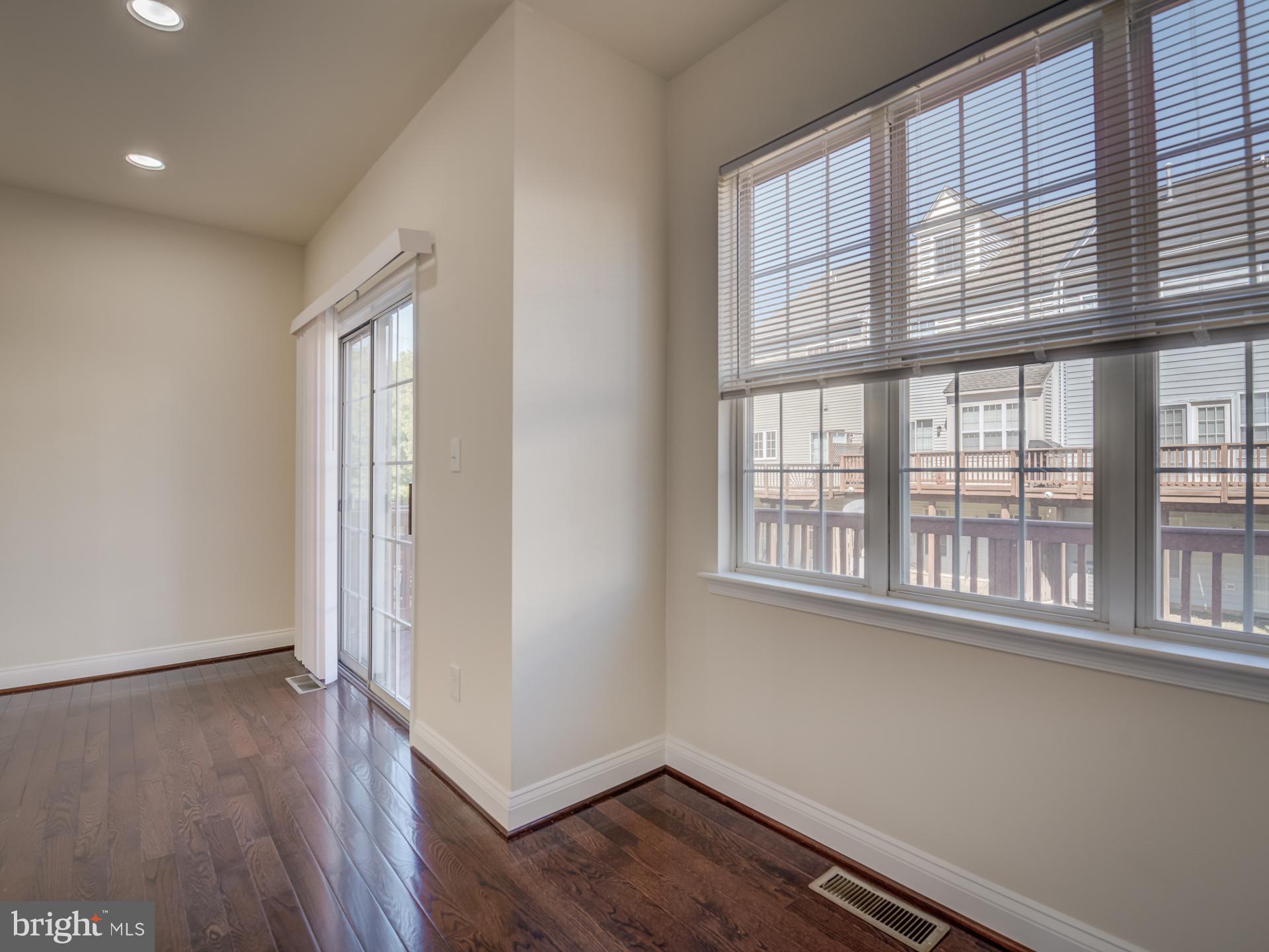 13510 Turquoise Lane Herndon, VA 20170 - Photo 18 of 54 an empty room with wooden floor and windows