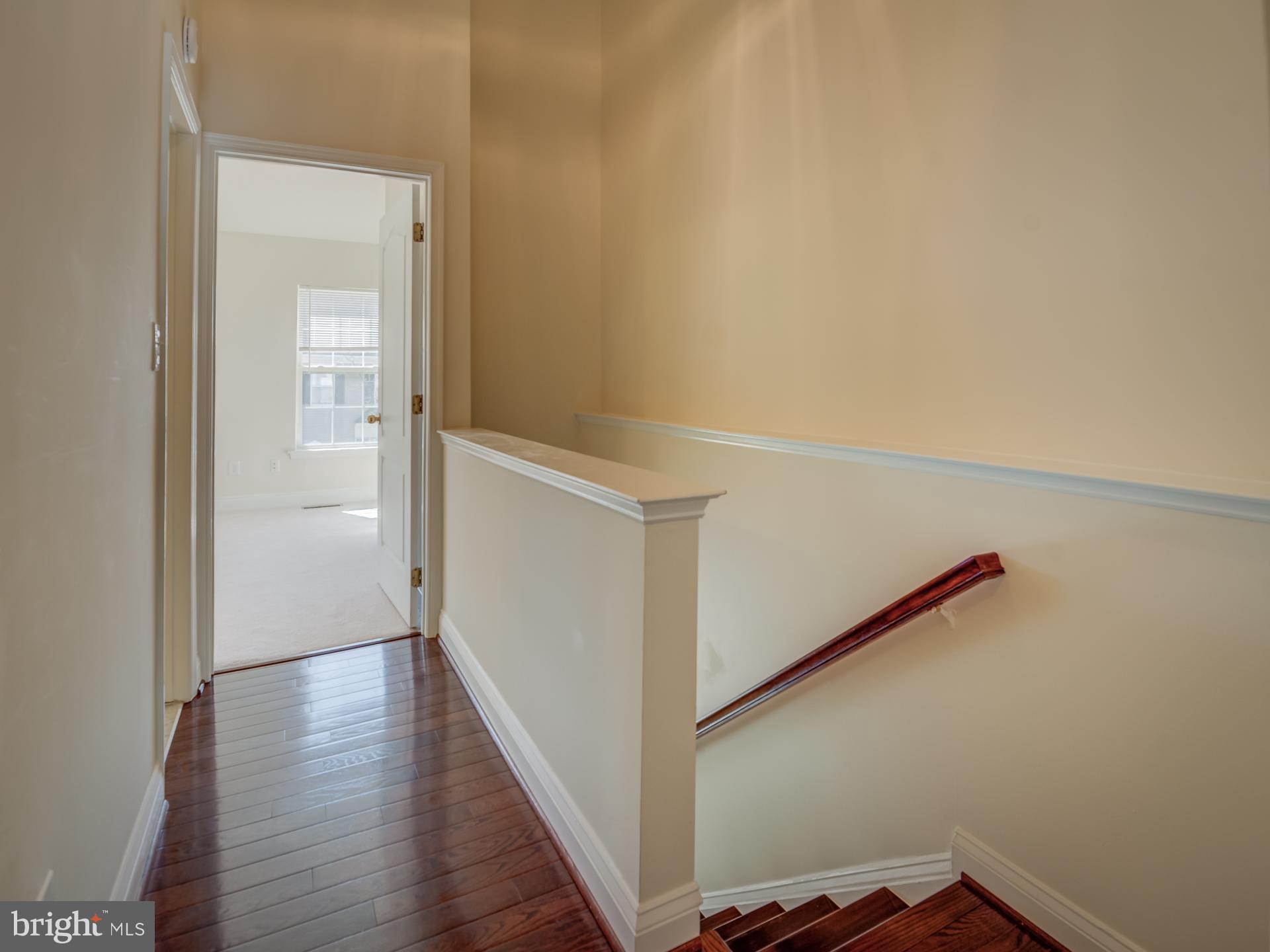13510 Turquoise Lane Herndon, VA 20170 - Photo 28 of 54 a view of a hallway with wooden floor