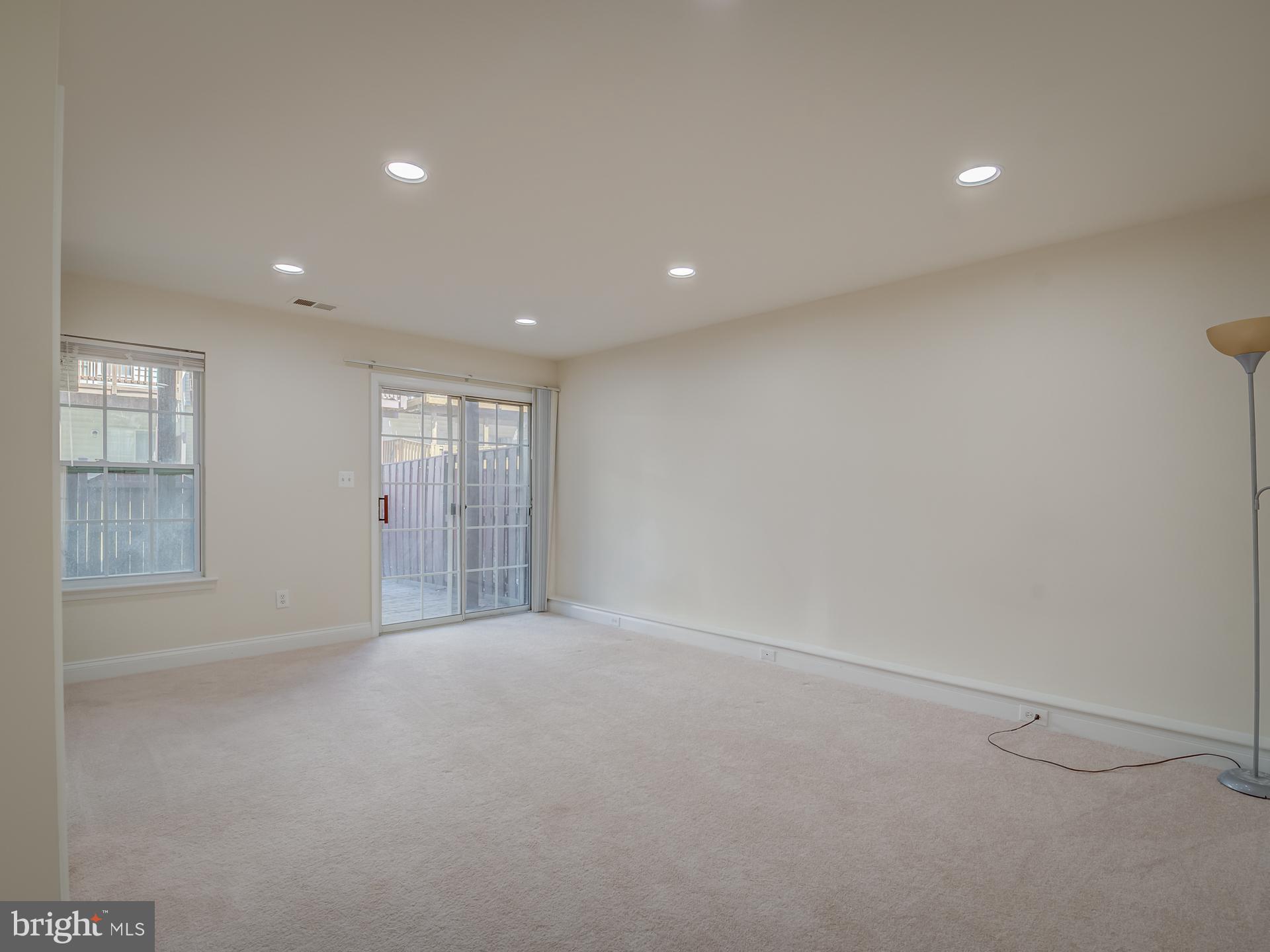 13510 Turquoise Lane Herndon, VA 20170 - Photo 47 of 54 a view of an empty room with wooden floor and windows