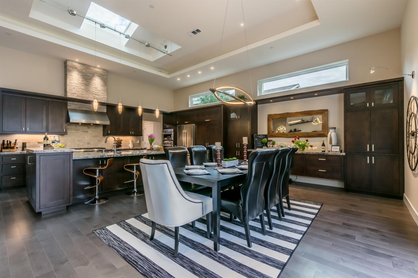 103 Arbuelo Way Los Altos, CA 94022 - Photo 11 of 45 a dining room with stainless steel appliances kitchen island granite countertop a table chairs and a view of living room