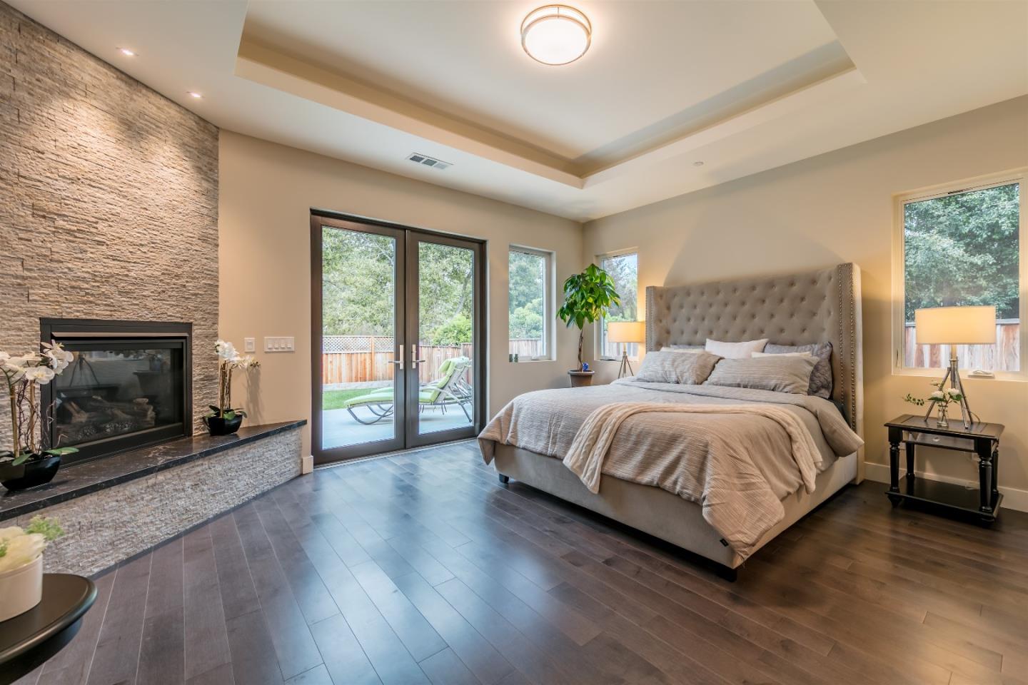 103 Arbuelo Way Los Altos, CA 94022 - Photo 21 of 45 a spacious bedroom with a large bed and a fireplace