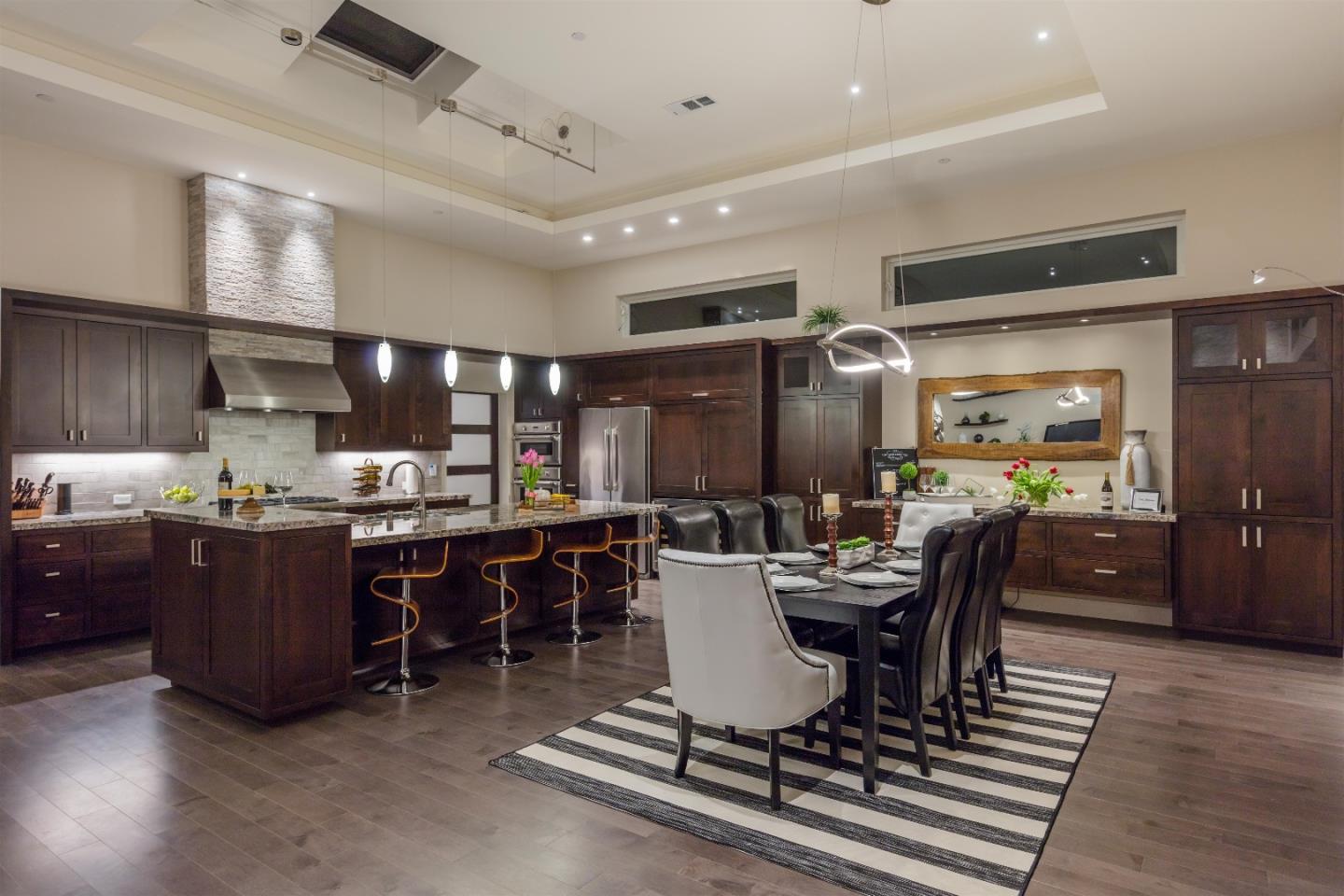 103 Arbuelo Way Los Altos, CA 94022 - Photo 35 of 45 a dining room with stainless steel appliances kitchen island granite countertop a table chairs a sink and a refrigerator