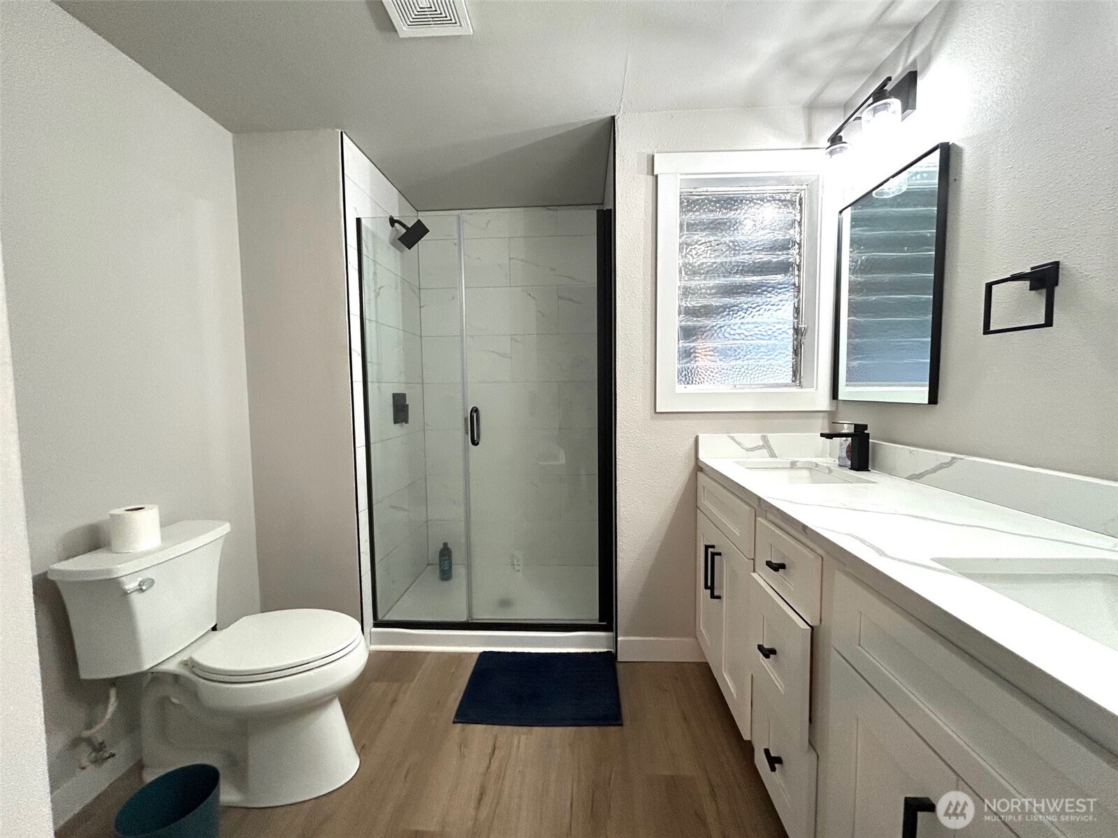 12643 156th Avenue Southeast Renton, WA 98059 - Photo 12 of 19 a bathroom with a sink a toilet and shower