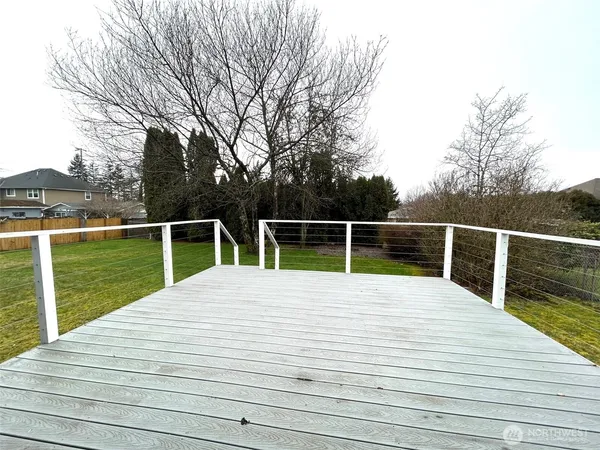 a view of a wooden deck with a yard