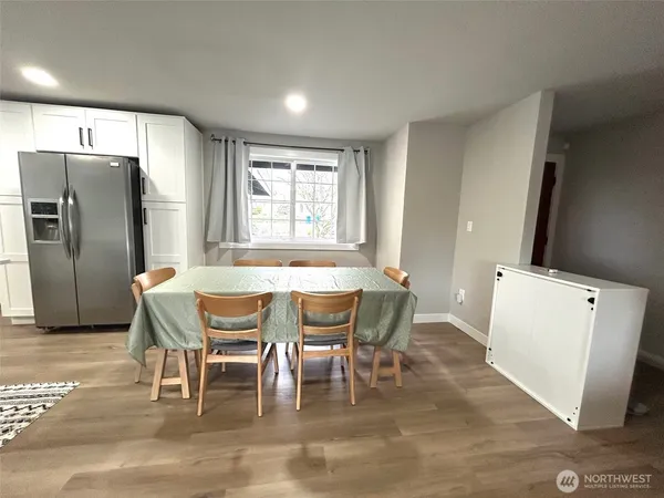 a view of a dining room with furniture and wooden floor