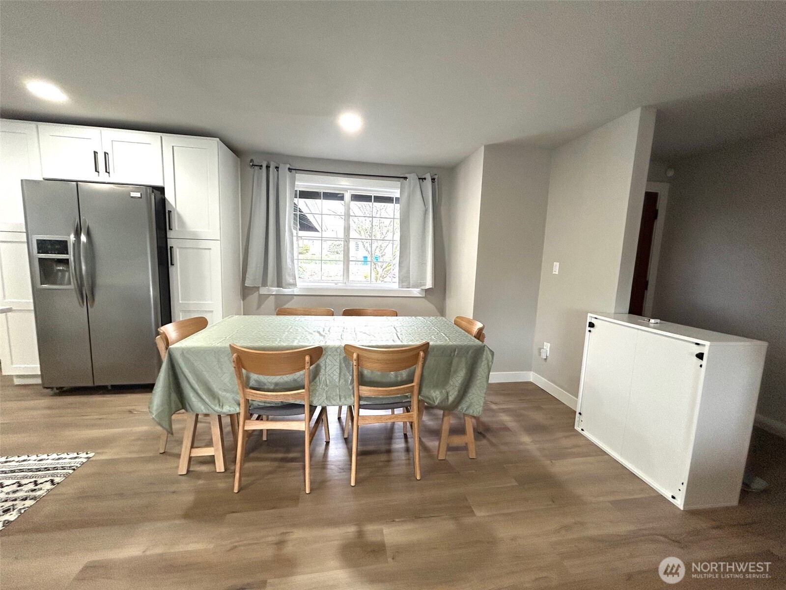 12643 156th Avenue Southeast Renton, WA 98059 - Photo 7 of 19 a view of a dining room with furniture and wooden floor
