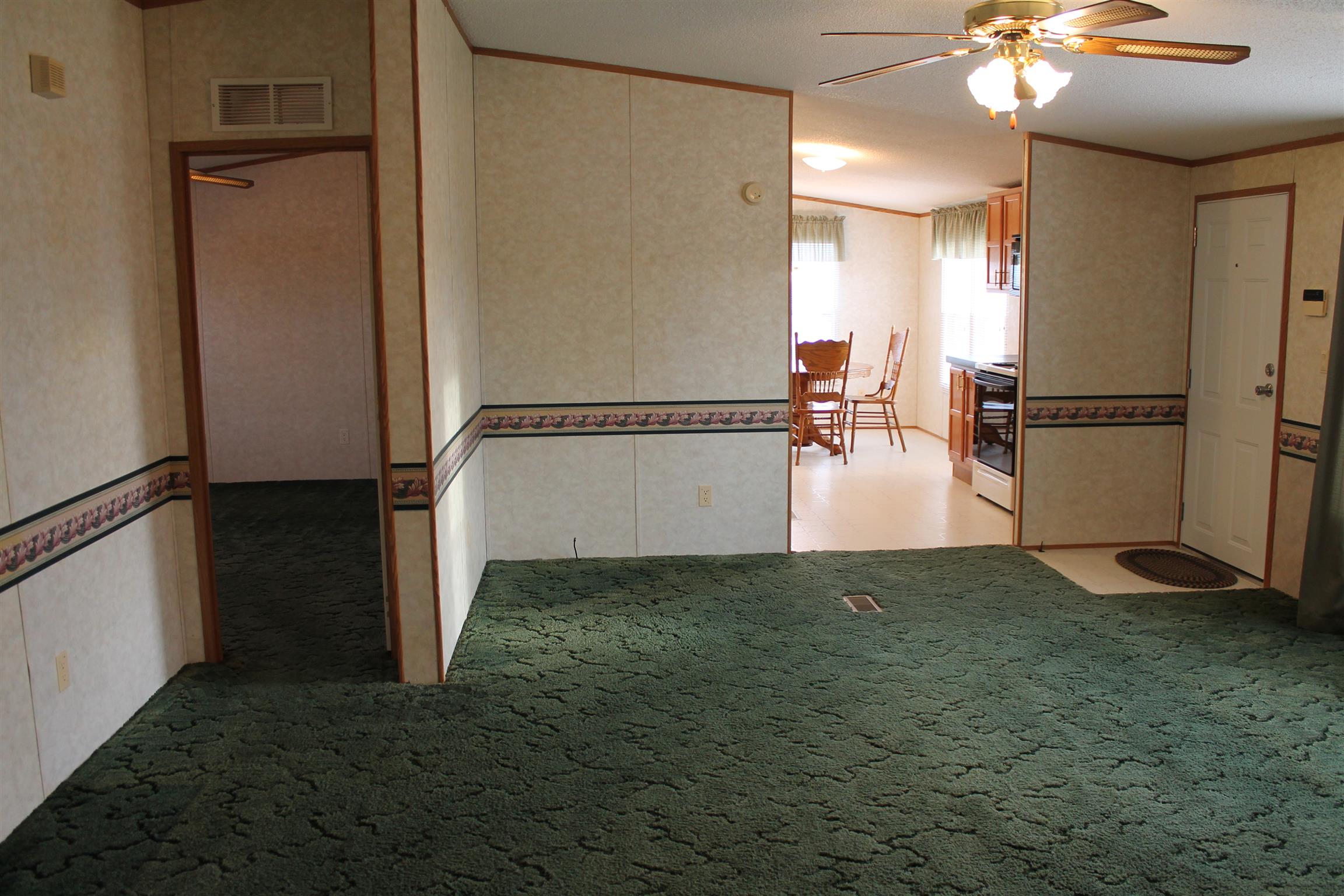 1925 Humphreys Co Line Road Dickson, TN 37055 - Photo 14 of 23 a view of a kitchen with a refrigerator and a ceiling fan
