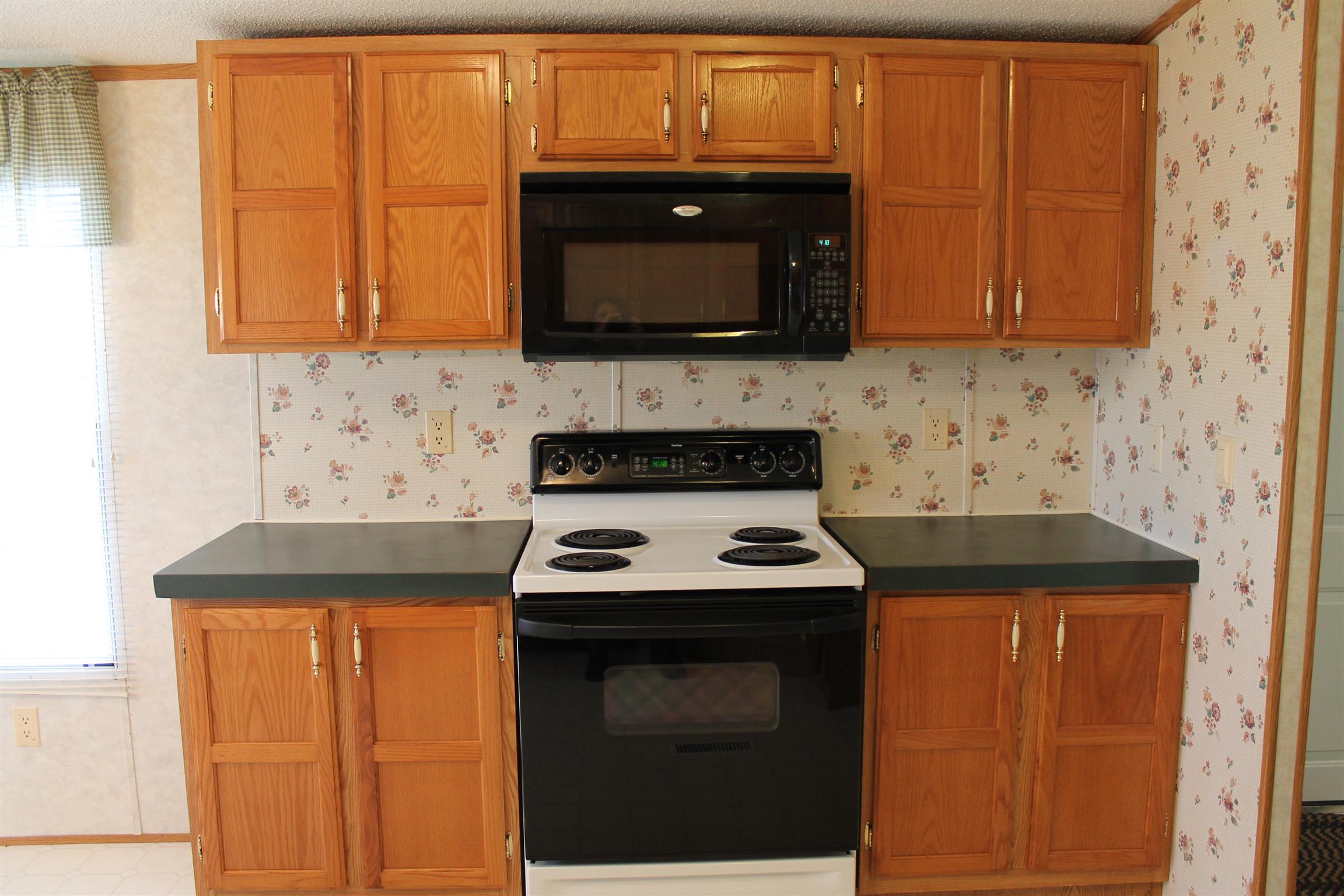 1925 Humphreys Co Line Road Dickson, TN 37055 - Photo 10 of 23 a kitchen with granite countertop a stove top oven microwave and cabinets
