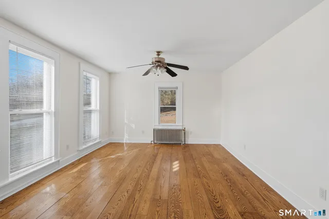 wooden floor in an empty room with a window