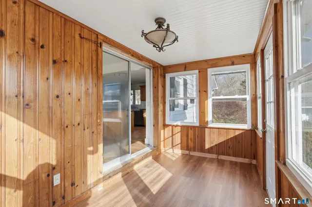 a view of an entryway with wooden floor and door