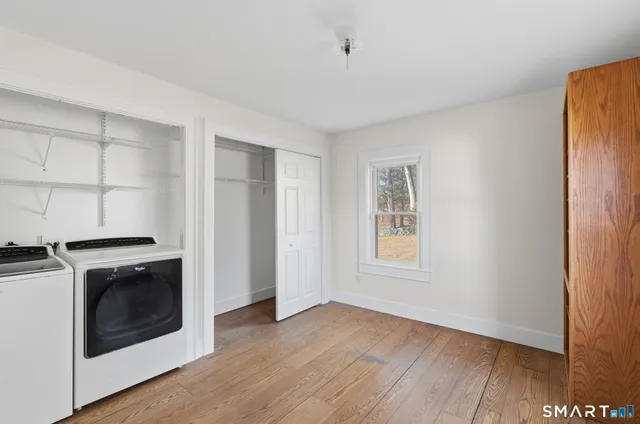 a view of a kitchen with wooden floor and electronic appliances