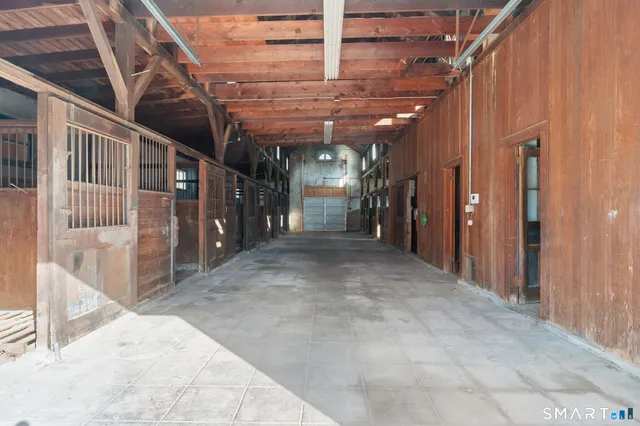 a view of a hallway with wooden walls